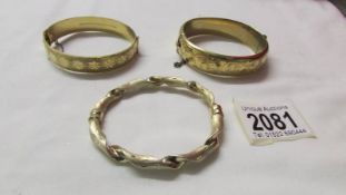 An 18ct gold plated bangle together with a rolled gold bangle and a silver bangle, mostly 1970/80's.