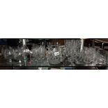 A good selection of drinking glasses with some sets of 6's and 4's and a jug