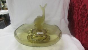 An early 20th century green glass rose bowl with fish centre.