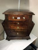 A dark wood stained magazine chest with cupboard