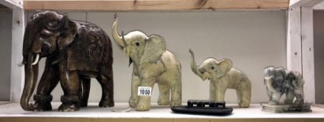 A wooden elephant and 3 other elephants etc ((largest white elephant has damage to ear)