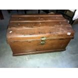 A large vintage metal steamer trunk