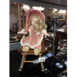 A dolls rocking chair and a doll