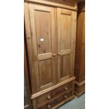 A good pine wardrobe with two drawer base.