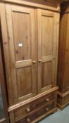 A good pine wardrobe with two drawer base.