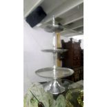 A tall metal three tier cake stand.