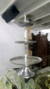 A tall metal three tier cake stand.