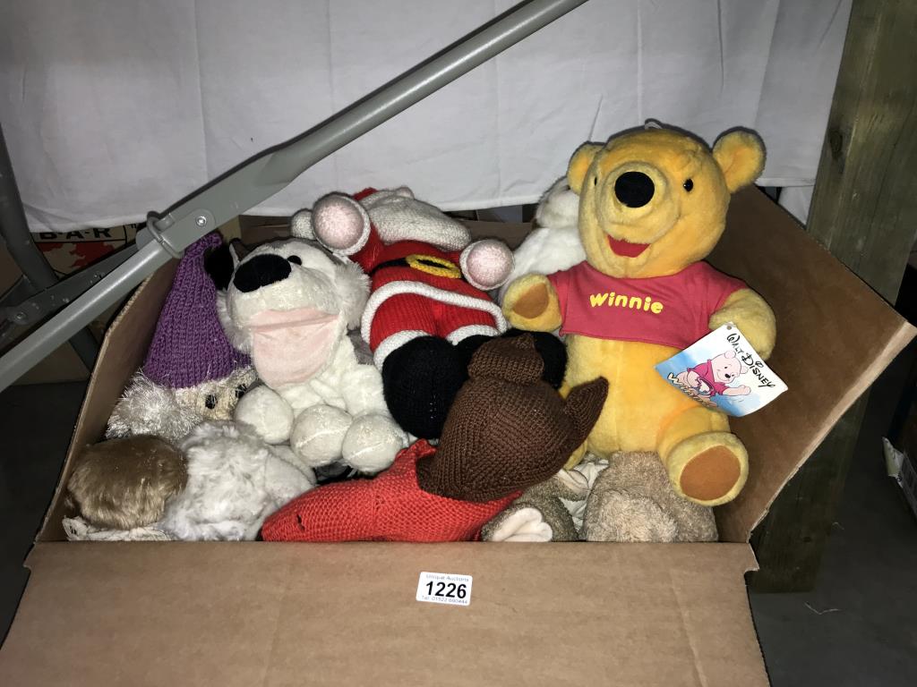 A quantity of soft toys including Winnie The Pooh and knitted toys