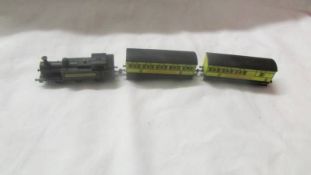 An 'N' gauge Graham Ferish Shredded Wheat loco and two carriages.