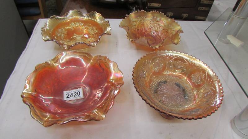 Four carnival glass marigold bowls - Imperial windmill, Fenton chrysanthemum,