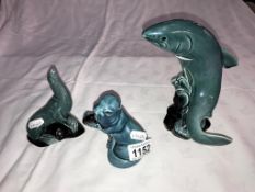 A Poole pottery salmon and 2 seals