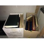 2 boxes of albums of photographs and postcards