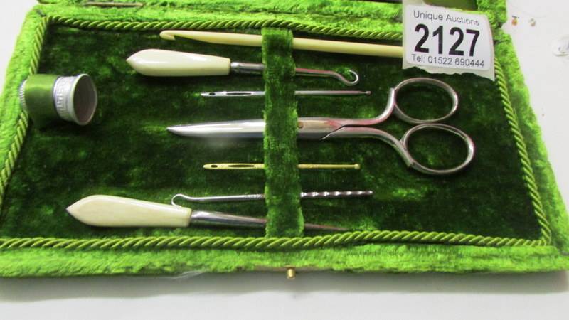 An early 20th century sewing kit in plush case. - Image 2 of 4