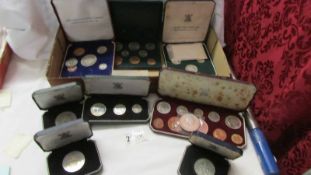 A quantity of cased coin sets.