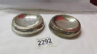 A pair of unmarked silver salts.