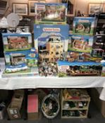 A huge collection of Sylvanian families boxed stables, school, bus, boutique, house etc,