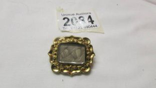 A mid 19th century mourning brooch dated 1857, inscribed Wm Kenington,