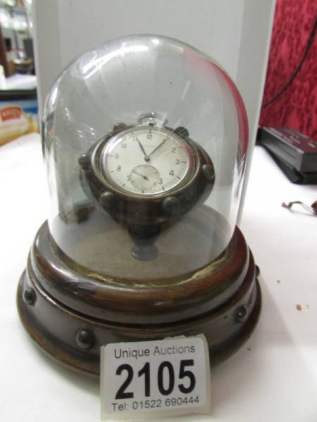 A Longines pocket watch in display case under dome.