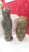 A carved hard wood tribal warrior figure and a wooden face mask.