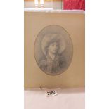 An oval pencil drawing of a lady signed Ellen Jowett.