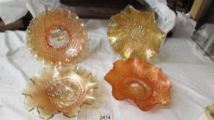 Four carnival glass marigold bowls - Fenton orange tree (bird & berry back), Fenton windflower,