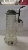 A tall glass beer stein.