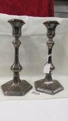 A pair of engraved silver plate candlesticks.