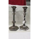 A pair of engraved silver plate candlesticks.