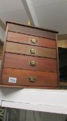 A small four drawer chest with brass handles (possibly apprentice piece).