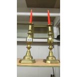 A pair of Victorian brass 'King of Diamond' candlesticks.