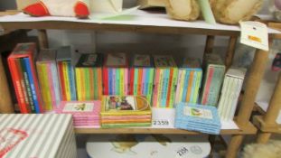 A collection of miniature children's books including Winnie the Pooh, Rupert Bear, Brambley Edge,