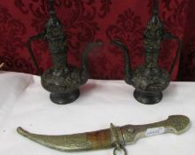 An Eastern dagger and a pair of metal ewers.