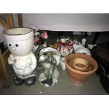 A quantity of terracotta flower pots and garden planters including novelty ones