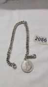 An antique silver kerb link chain with silver shilling dated 1895. 55.1 grams.