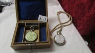 A wooden pocket watch box and two pocket watches.