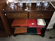 A mahogany effect small wall unit with 2 drawers