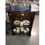 A dark wood stained small bookcase with drawer