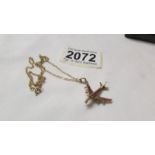 A 9ct gold airplane pendant on 38 cm chain (chain a/f). 3.8 grams.