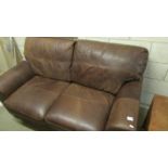 A new two seater soft brown leather sofa.