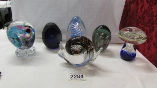 Six glass paperweights including snail, mushroom etc.