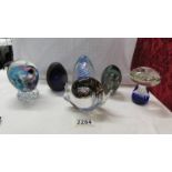 Six glass paperweights including snail, mushroom etc.