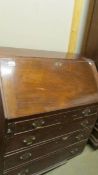 A mahogany bureau, missing base.