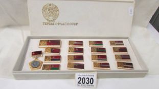A boxed set of Soviet Union CCCP pin badges, 17 badges in total possibly showing republic flags.