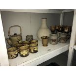 A quantity of stoneware pottery, mugs, goblets,