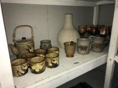 A quantity of stoneware pottery, mugs, goblets,