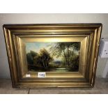 A 19th/20th century oil on board of wooded water scene (frame 42cm x 31cm,