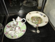 A vintage food warming plate and a miniature tea set on tray.