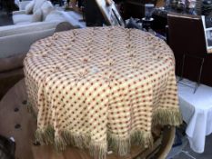 A large round deep buttoned stool/pouffe on castors