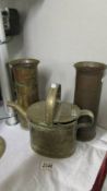 A pair of brass shell cases and a brass watering can.