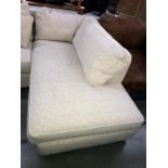 A cream fabric covered single end sofa